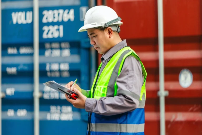 Industrial,Workers,Conducting,Container,Inspections,Inside,A,Shipping,Facility.,Reviewing