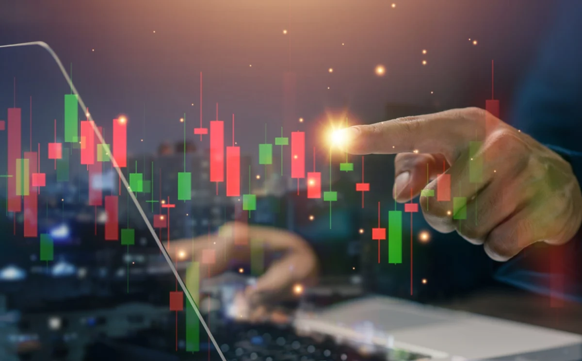 Stock,Trading,Analysis,Concept,With,Investor,Hand,Pointing,At,Candlestick
