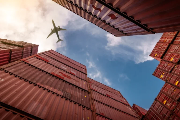Airplane,Flying,Above,Container,Logistic.,Cargo,And,Shipping,Business.,Container