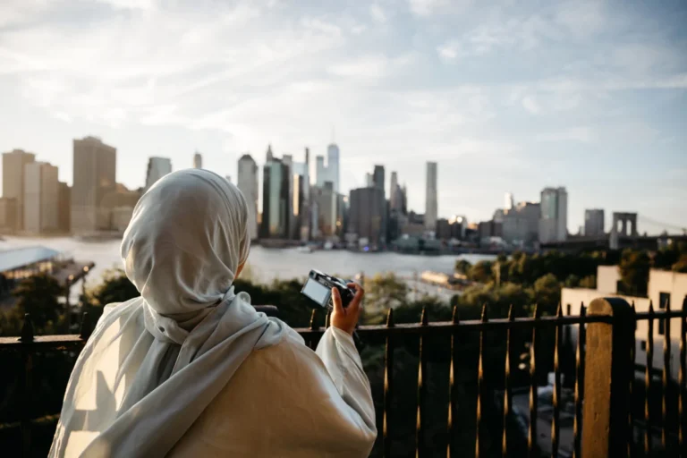 Young photographer taking picture to New York skyline