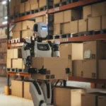 Futuristic,Humanoid,Robot,Transports,A,Cardboard,Package,In,A,Distribution
